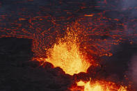 A close up of the Southern active segment of the original fissure of an active volcano in Grindavik on Iceland's Reykjanes Peninsula, Tuesday, Dec. 19, 2023. (AP Photo/Marco Di Marco)