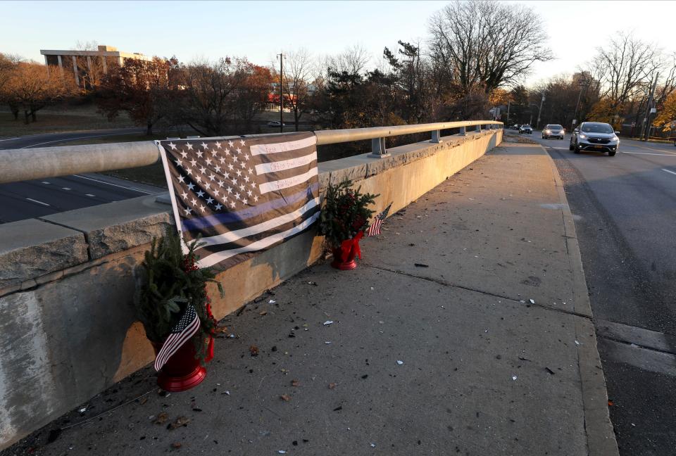 The sun comes up on a memorial display on Tuckahoe Road over the Sprain Brook Parkway in Yonkers, Dec. 2, 2022, for a Yonkers Police officer that died after a collision with an automobile and a Bee Line bus the day before. 