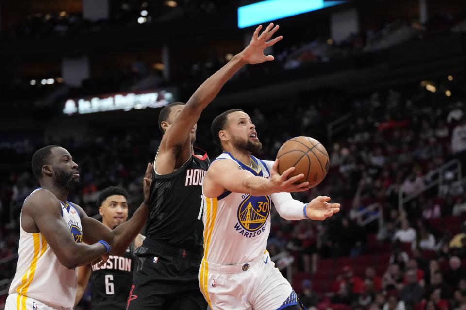 Golden State Warriors' Stephen Curry (30) shoots as Houston Rockets' Jabari Smith Jr. (1) defends during the second half of an NBA basketball game Monday, March 20, 2023, in Houston. The Warriors won 121-108. (AP Photo/David J. Phillip)