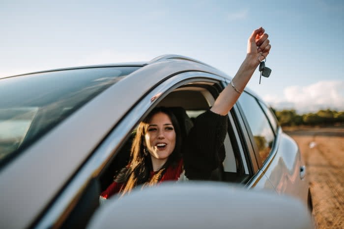 A person celebrating after buying a car