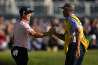 Justin Thomas celebrates with his caddie Jim "Bones" Mackay after winning the PGA Championship golf tournament in a playoff against Will Zalatoris at Southern Hills Country Club, Sunday, May 22, 2022, in Tulsa, Okla. (AP Photo/Eric Gay)