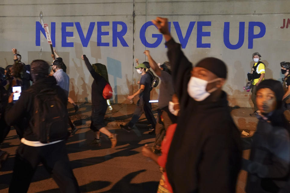 Protesters march, Thursday, Sept. 24, 2020, in Louisville, Ky. Authorities pleaded for calm while activists vowed to fight on Thursday in Kentucky's largest city, where a gunman wounded two police officers during anguished protests following the decision not to charge officers for killing Breonna Taylor. (AP Photo/John Minchillo)