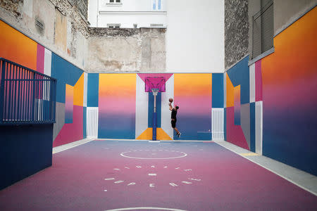 The basketball court Pigalle Duperre, painted in shades of purple, pink, yellow, orange and blue, and with a rubber-surfaced court, is sandwiched into a row of buildings in the 9th arrondissement, is pictured in Paris, France, July 31, 2018. REUTERS/Benoit Tessier