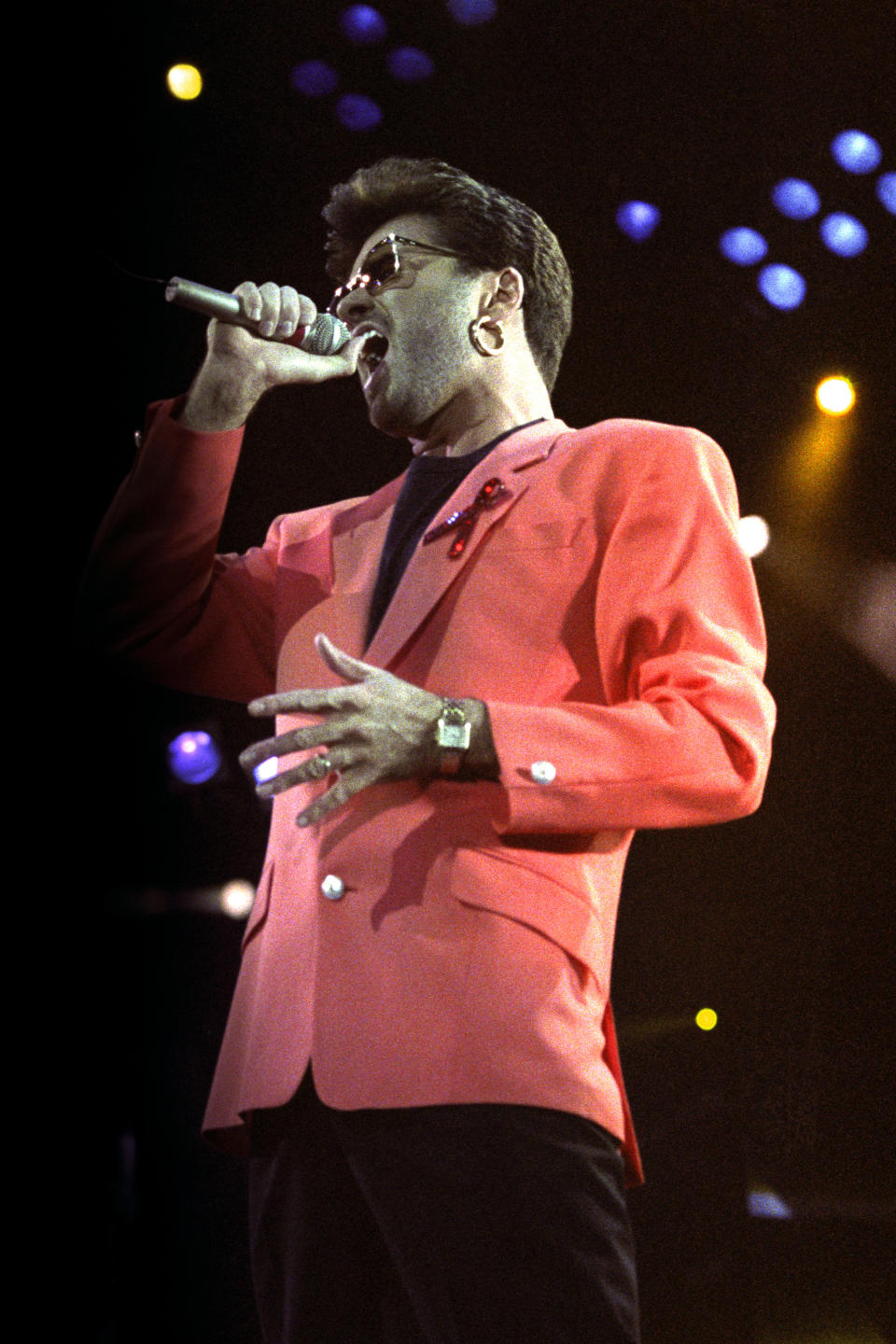 George Michael singing on stage during the concert.