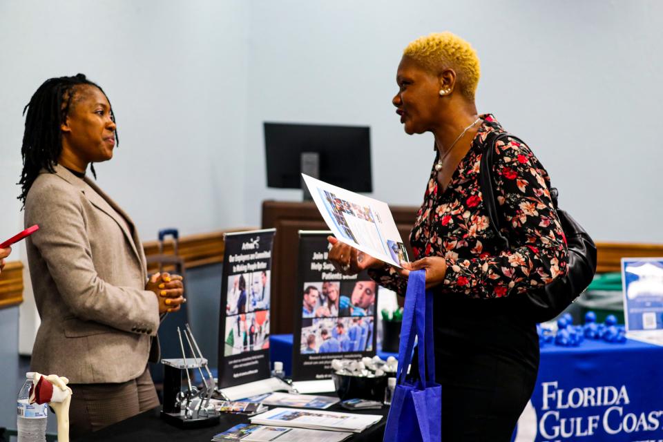 Jacqueline Garry, of Fort Myers and served in the Navy for 3 years, stopped at the  Artherx table as she searches for a job. FGCU held a SWFL Veterans Expo and Job Fair Thursday, April 14, 2022. 