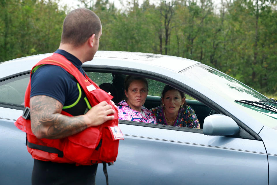 Letisha Barton asks Coast Guard Officer David Kelley about her home in the flood waters in Lumberton.