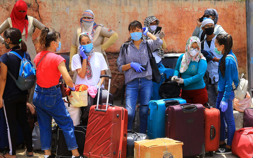 Migrants from North-east stand await special trains and buses in Jaipur, India to return home amid the coronavirus lockdown. Source: Getty