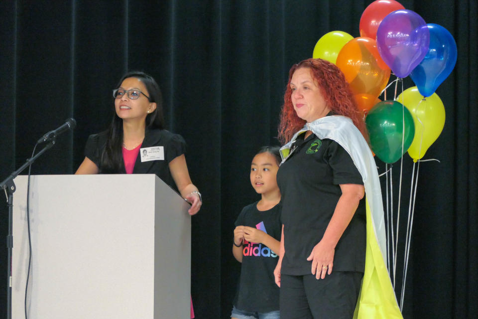 Angela Kelly (right) on stage with Minh Dang-Do (left) and her younger daughter, Ella Do, 7 (middle). Kelly is one of five recipients of the 2024 Florida School Lunch Heroes award.
