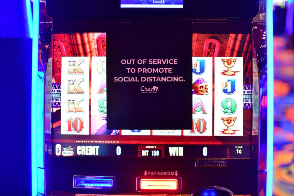 A sign promotes social distancing on a slot machine in disuse at Ocean Casino after it reopened on July 3, 2020 in Atlantic City, New Jersey.