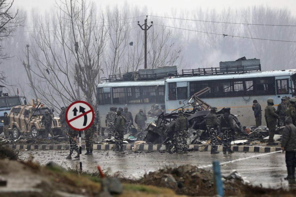 FILE - In this Feb. 14, 2019, file photo, Indian paramilitary soldiers stand by the wreckage of a bus after an explosion in Pampore, Indian-controlled Kashmir. In the world’s largest democracy, few issues reach as broad a consensus as Kashmir, that the Muslim-majority region must remain part of Hindu-majority India. Modi is using this, and a February attack on Indian paramilitary forces in Kashmir, to consolidate the Hindu vote in India’s five-week elections that conclude May 21 to bolster his campaign-slogan claim to be India’s chowkidar, or watchman. (AP Photo/Umer Asif, File)