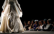 <p>A model walks down the runway during an event dubbed, “Modest Fashion Day”, the first of its kind in Israel, whereby designers showed off their clothing creations aimed at Orthodox Jewish women who adhere to strict dress codes, in Jerusalem on Feb. 23, 2017. (Photo: Ronen Zvulun/Reuters) </p>