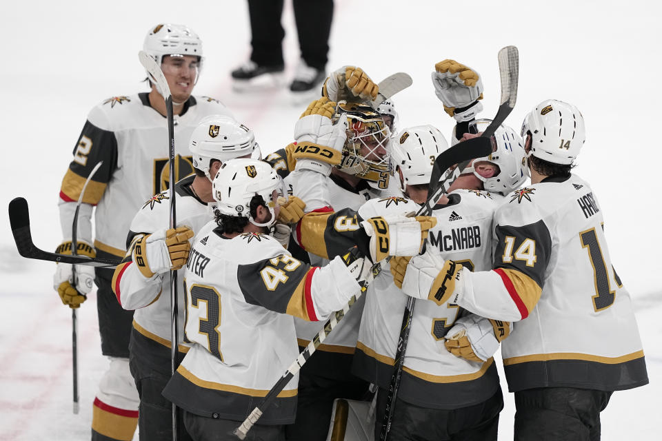 Vegas Golden Knights center Jack Eichel, second from right, celebrates with teammates his game-winning goal against the Dallas Stars during overtime of an NHL hockey game, Wednesday, Nov. 22, 2023, in Dallas. The Golden Knights won 2-1. (AP Photo/Tony Gutierrez)