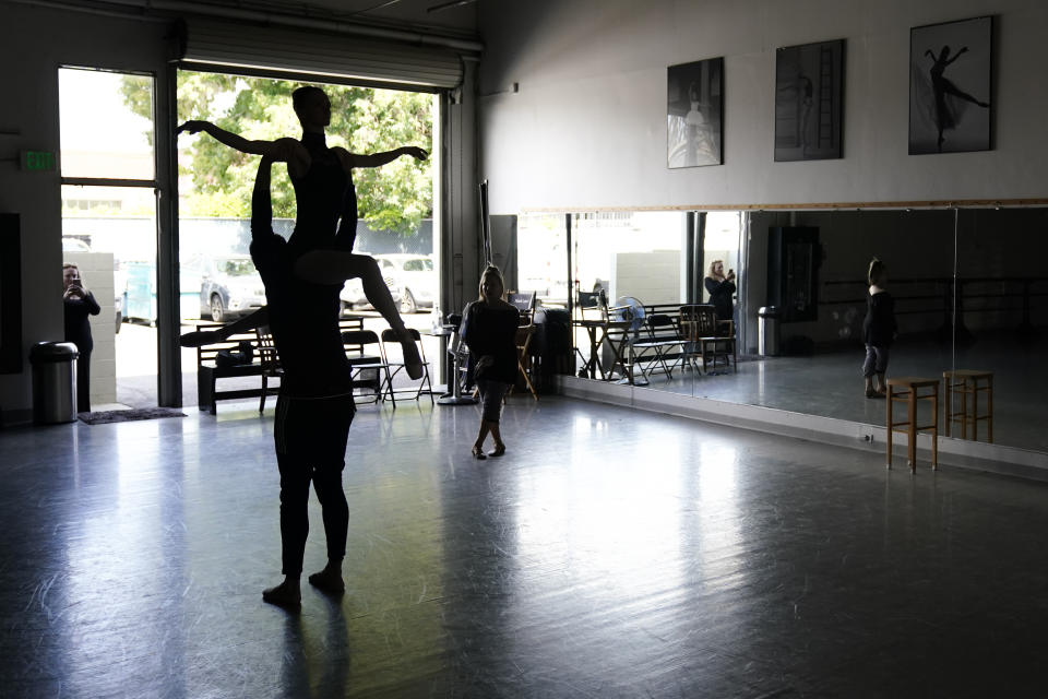 Adrian Blake Mitchell and Andrea Laššáková rehearse with Francine Kessler Lavac, right, on Monday, April 18, 2022, in Santa Monica, Calif. Mitchell and Laššáková left their positions at the Mikhailovsky Ballet Theatre in St. Petersburg and fled Russia ahead of the invasion of Ukraine. (AP Photo/Ashley Landis)