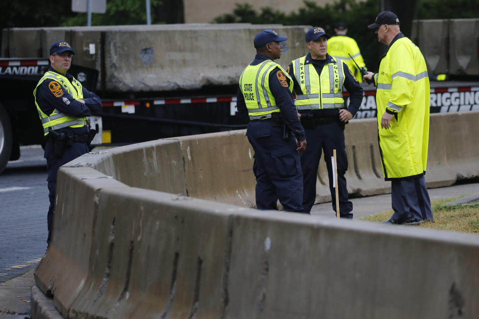 State and Capitol police patrol the area where workers for The Virginia Department of General Services are installing concrete barriers around the statue of Confederate General Robert E. Lee on Monument Avenue Wednesday, June 17, 2020, in Richmond, Va. The barriers are intended to protect the safety of demonstrators as well as the structure itself. (AP Photo/Steve Helber)