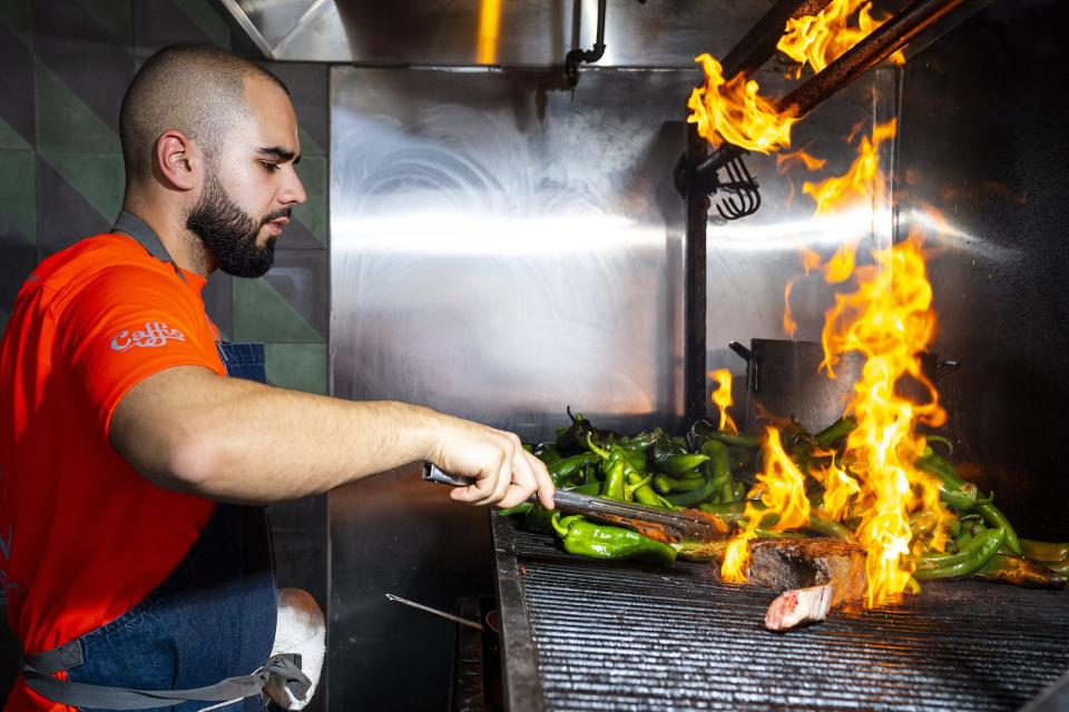 Chef Roberto Centeno grills a tomahawk steak at Bacanora on Wednesday, March 2, 2022, in Phoenix.