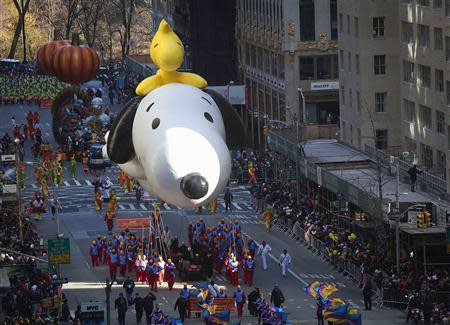 The Snoopy and Woodstock balloon float makes its way down 6th Avenue during the 87th Macy's Thanksgiving day parade in New York November 28, 2013. REUTERS/Carlo Allegri