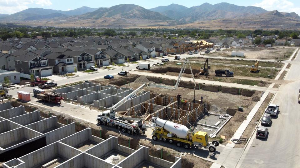 Workers pour concrete at the Ivory Homes Gabler’s Grove development in Magna on Tuesday, July 25, 2023. | Scott G Winterton, Deseret News