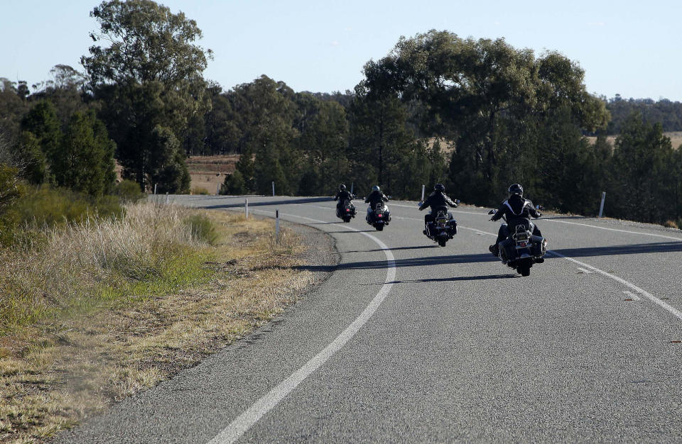 In this May 25, 2013 photo, four motorcycle tourists ride along the highway towards the town of Griffith, 573 kilometers (356 miles) from Sydney, Australia, during a seven-day, 3,000-kilometer (1,900-mile) journey across the Outback. (AP Photo/Rob Griffith)