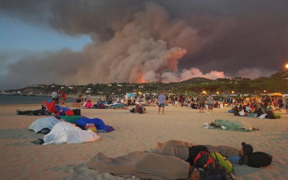 People are forced to sleep on the beach at Bormes-les-Mimosas in the Var region in southern France  - Credit: Splash News