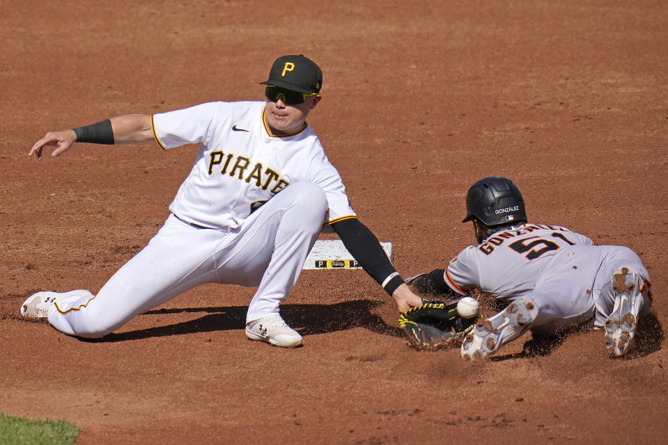 Pittsburgh Pirates second baseman Diego Castillo, left, cannot handle the throw from catcher Tyler Heineman (not shown) as San Francisco Giants' Luis Gonzalez (51) safely steals second base during the second inning of a baseball game in Pittsburgh, Saturday, June 18, 2022. (AP Photo/Gene J. Puskar)