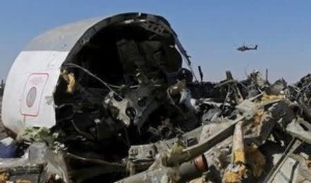 An Egyptian military helicopter flies over debris from a Russian airliner which crashed at the Hassana area in Arish city, north Egypt, in this November 1, 2015 file photo. REUTERS/Mohamed Abd El Ghany/Files