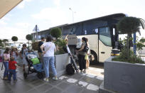 Russian diplomatic staff arrive on a bus at Sofia's Airport, Bulgaria, Sunday, July 3 2022. Two Russian airplanes were set to depart Bulgaria on Sunday with scores of Russian diplomatic staff and their families amid a mass expulsion that has sent tensions soaring between the historically close nations, a Russian diplomat said. (AP Photo/Valentina Petrova)