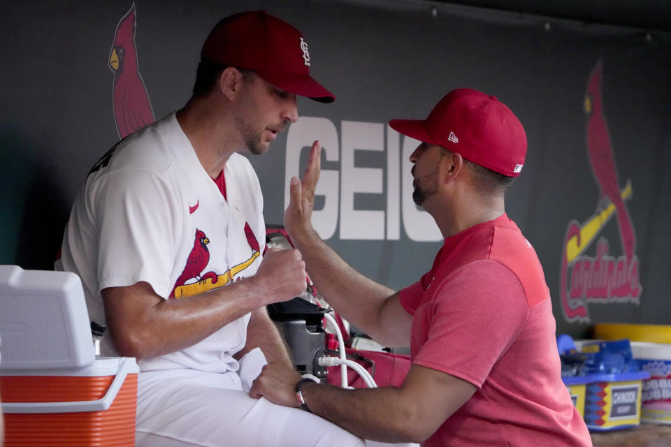 St. Louis Cardinals starting pitcher Adam Wainwright, left, talks with manager Oliver Marmol after being removed during the second inning of a baseball game against the Houston Astros Thursday, June 29, 2023, in St. Louis. (AP Photo/Jeff Roberson)