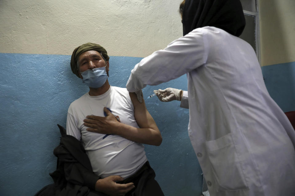 A man receives the Sinopharm COVID-19 vaccine at a vaccination center, in Kabul, Afghanistan, Wednesday, June 16, 2021. In Afghanistan, where a surge threatens to overwhelm a war-battered health system, 700,000 doses donated by China arrived over the weekend, and within hours, "people were fighting with each other to get to the front of the line," said Health Ministry spokesman Dr. Ghulam Dastigir Nazari. (AP Photo/Rahmat Gul)