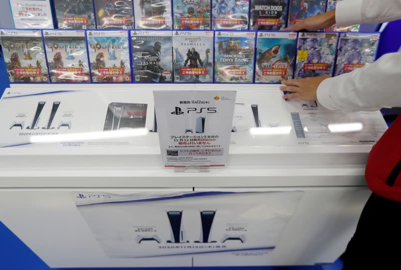 A sign announcing that the new Sony PlayStation 5 gaming console will not be sold by over-the-counter sales on the launch day is displayed in Tokyo