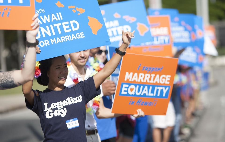 Keri Bias holds a sign in support of same sex marriage in Honolulu