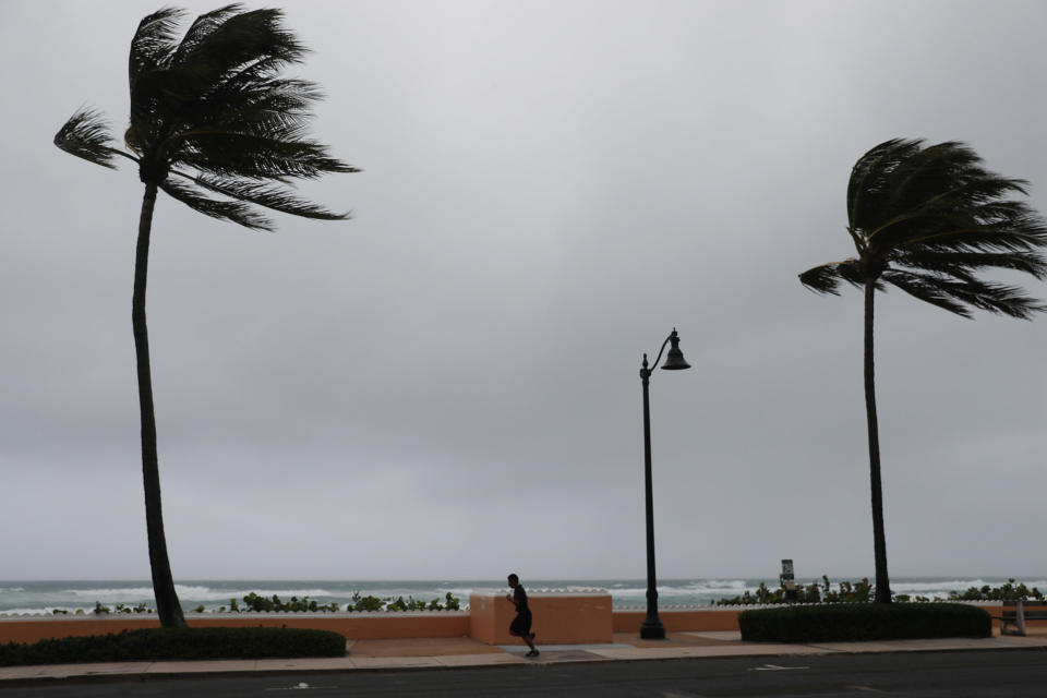 A runner is seen as Tropical Storm Isaias passes through the area on August 2, 2020 in Deerfield Beach, Florida. The storm is brushing along the east coast of Florida and tropical storm conditions will extend northward along the coasts of Georgia and South Carolina. / Credit: Getty