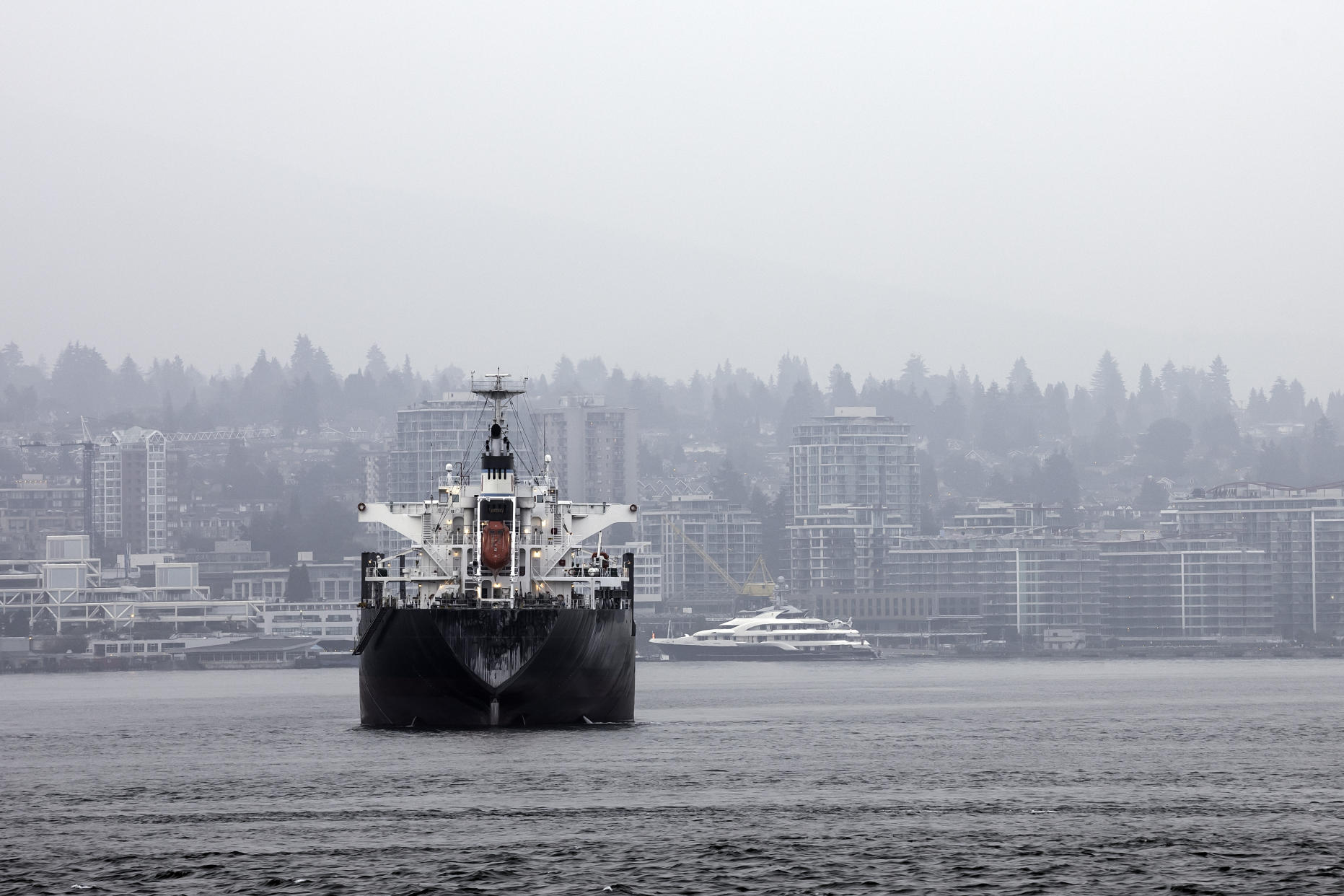 Cargo ship at Port Vancouver, Canada. The smoke from wildfires covers the sky. The World Wildlife Fund Canada found ships in Canadian waters generate 147 billion litres of operational waste each year. (Getty Images)