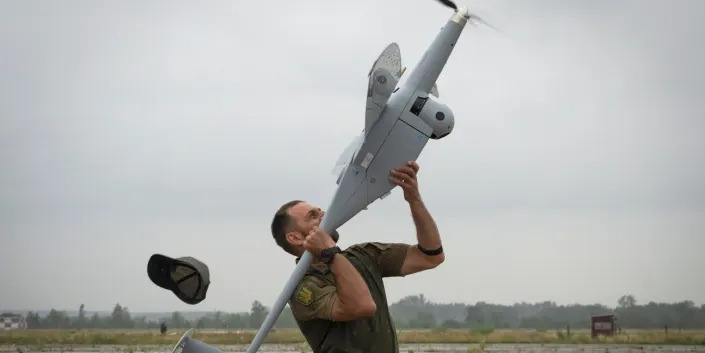 A Ukrainian soldier holds a drone