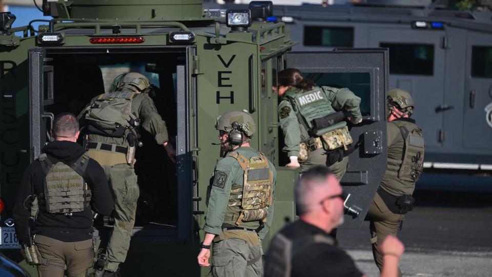 Law enforcement officials load into a vehicle in Lewiston ((Photo by ANGELA WEISS / AFP) (Photo by ANGELA WEISS/AFP via Getty Images))