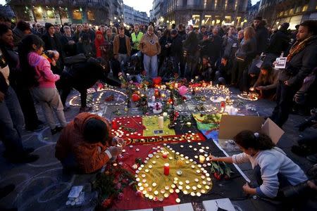 People gather around a memorial in Brussels following bomb attacks in Brussels, Belgium, March 22, 2016. REUTERS/Charles Platiau