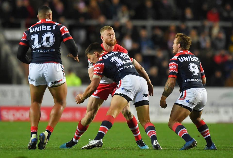 St Helens’ England prop Luke Thompson is tackled by Sydney Roosters’ Victor Radley (Dave Howarth/PA) (PA Archive)