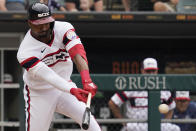 Chicago White Sox's Eloy Jimenez hits a single against the Detroit Tigers during the first inning of a baseball game in Chicago, Sunday, Aug. 14, 2022. (AP Photo/Nam Y. Huh)