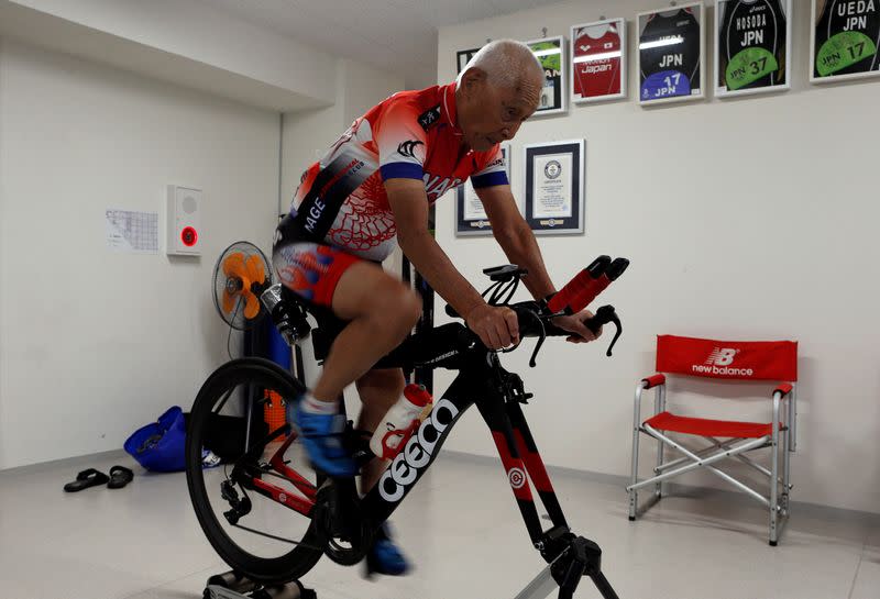 Hiromu Inada, redord holder of the oldest person to complete an Ironman World Championship, works out on his bike in Chiba, Japan