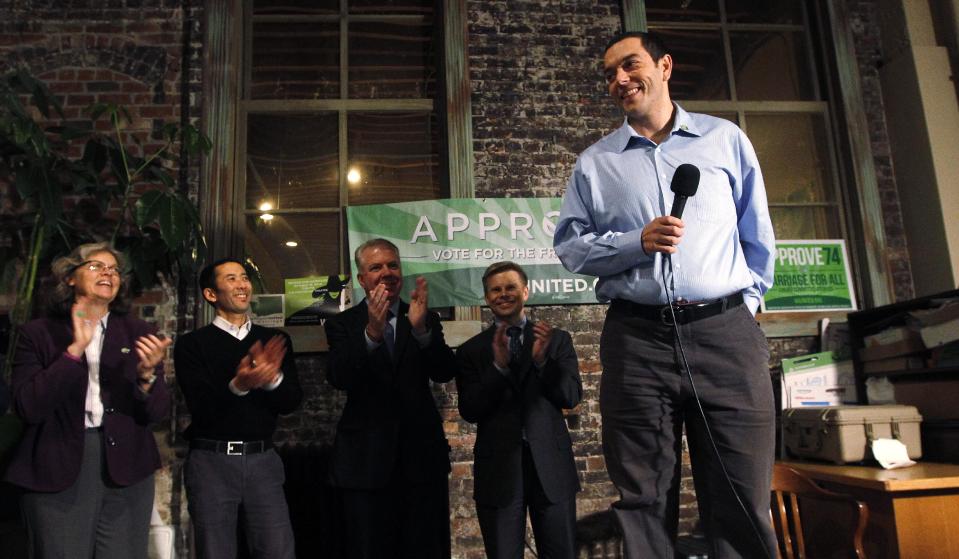 Zach Silk, campaign manager for Washington United for Marriage, is applauded as be begins to speak at a news conference by supporters of Referendum 74, which would uphold the state's new same-sex marriage law, Wednesday, Nov. 7, 2012, in Seattle. Supporters of gay marriage in Washington state declared victory Wednesday, saying they don't see a way for their opponents to prevail as votes continue to trickle in on Referendum 74. R-74 asked Washingtonians to approve or reject a state law legalizing same-sex marriage that lawmakers passed earlier this year. That law was signed by Gov. Chris Gregoire but has been on hold pending the election's outcome. With about half of the expected ballots counted Tuesday night, R-74 was passing with 52 percent of the vote. (AP Photo/Elaine Thompson)