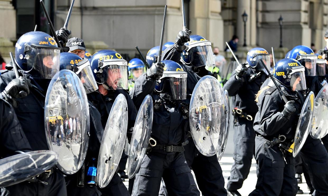 <span>‘There are ordinary humans behind those riot shields.’</span><span>Photograph: Peter Powell/AFP/Getty Images</span>