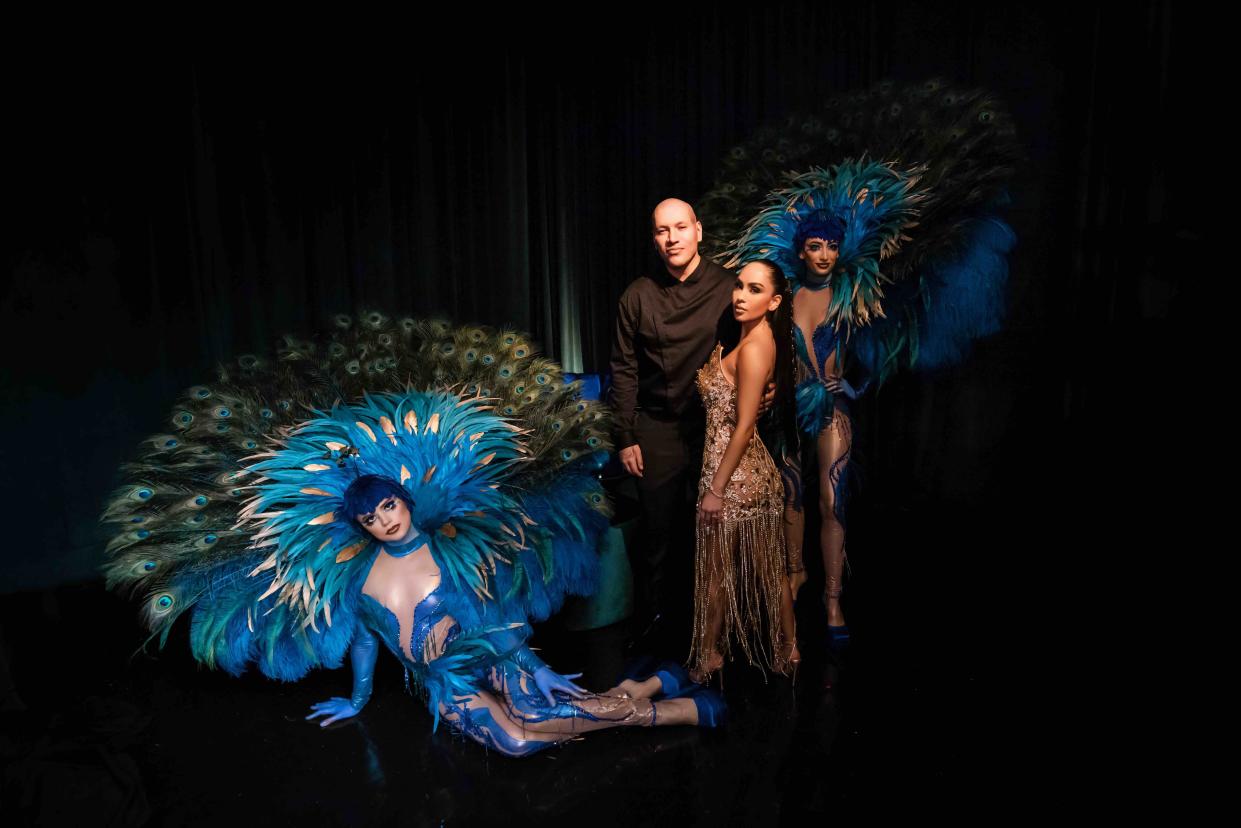 Afrika Chao pictured in her third custom-made dress with husband Anthony Osorio and two 'peacock' dancers. (Michael Anthony Studios)