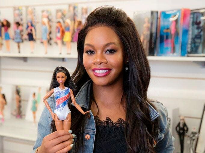 Gabby Douglas holds a Barbie version of herself