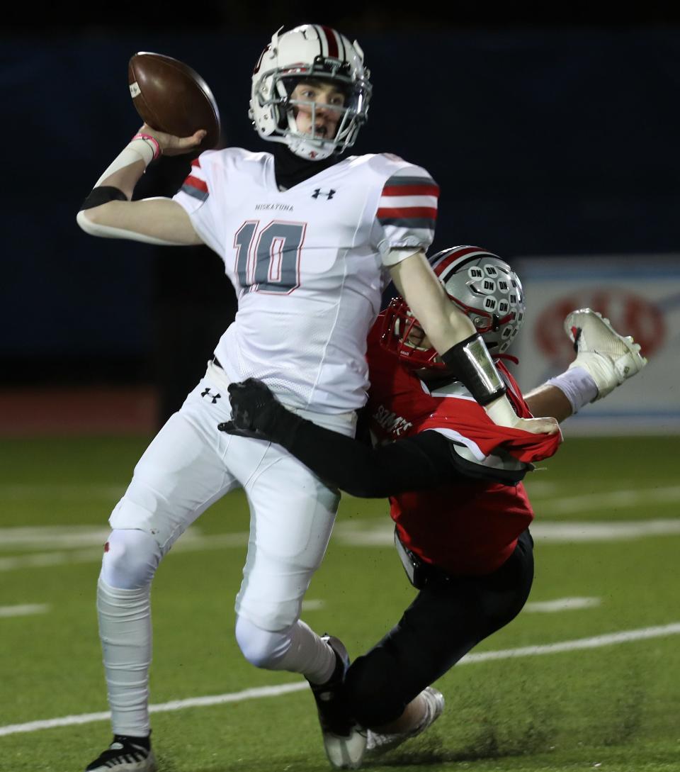 Somers' Ryan Cole (50) puts pressure on Niskayuna's Ethan Gilson (10) during the Class A football state semifinal at Middletown High School Nov. 25, 2022. Somers won the game 35-7.