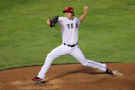 ARLINGTON, TX - OCTOBER 23: Derek Holland #45 of the Texas Rangers pitches in the second inning during Game Four of the MLB World Series against the St. Louis Cardinals at Rangers Ballpark in Arlington on October 23, 2011 in Arlington, Texas. (Photo by Doug Pensinger/Getty Images)