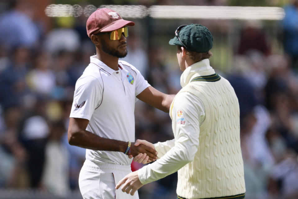 The West Indies' Kraigg Brathwaite, left, shakes hands with Australia's Steve Smith after Australia won on the fourth day of their cricket test match in Adelaide, Sunday, Nov. 11, 2022. (AP Photo/James Elsby)