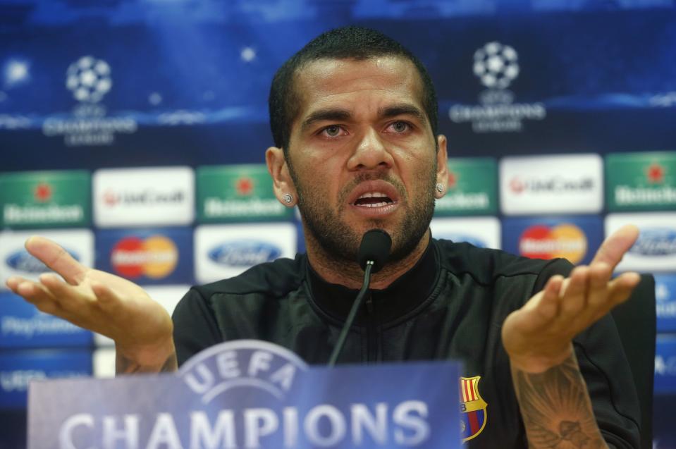 Barcelona's Dani Alves gestures during a news conference at Joan Gamper training camp, near Barcelona March 31, 2014. Barcelona and Atletico Madrid will play their Champions League quarter-final, first leg soccer match on Tuesday. REUTERS/Albert Gea (SPAIN - Tags: SPORT SOCCER)