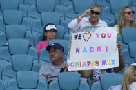 Fans of Naomi Osaka of Japan hold up a sign before the start of Osaka's match against Alison Riske, during the Miami Open tennis tournament, Monday, March 28, 2022, in Miami Gardens, Fla. (AP Photo/Wilfredo Lee)