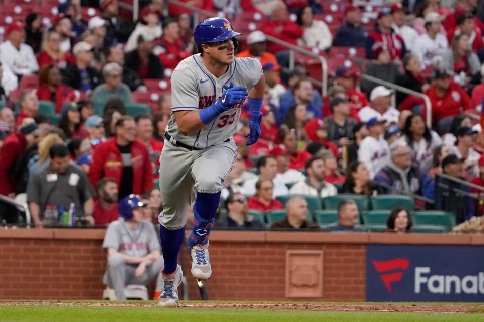 New York Mets' James McCann heads toward an RBI double during the third inning of a baseball game against the St. Louis Cardinals Tuesday, April 26, 2022, in St. Louis.