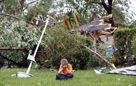 Charles Athrom, 7 sits in front of his destroyed home after a tornado swept through the area the previous night in Van, Texas May 11, 2015. REUTERS/Mike Stone