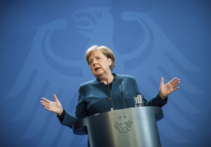 German Chancellor Angela Merkel speaks at a press conference about coronavirus, in Berlin, Sunday, March 22, 2020. German authorities have issued a ban on more than two people meeting outside of their homes, which they believe will be easier to follow than locking people in their homes. The vast majority of people recover from the new coronavirus. According to the World Health Organization, most people recover in about two to six weeks, depending on the severity of the illness. (Michael Kappeler/Pool photo via AP)